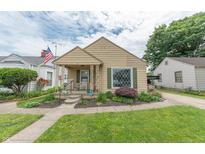 Charming single-story home with a well-manicured lawn and inviting front porch, perfect for relaxing at 1913 Pennsylvania St, Columbus, IN 47201