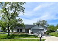 Charming single-Gathering home featuring an attached garage and well-maintained front lawn at 199 Fountain Lake S Dr, Shelbyville, IN 46176