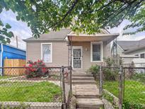 Charming home featuring a cozy front porch, tidy front yard, and an inviting entrance at 2006 N Olney St, Indianapolis, IN 46218