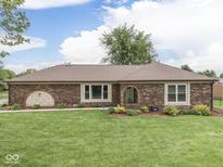 Charming brick home featuring a well-manicured lawn and inviting landscape elements at 2010 Alexandria Dr, Greenfield, IN 46140