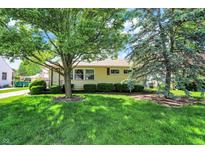 Charming single-story home with a lush green lawn and mature trees, offering great curb appeal at 2110 Fisher Ave, Speedway, IN 46224