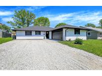 Charming single-story home with a well-maintained lawn and gravel driveway at 3237 Thurston Dr, Indianapolis, IN 46224