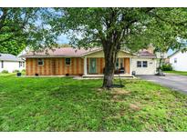 Charming brick home with a well-maintained lawn, a front porch, and mature trees creating curb appeal at 356 Daugherty St, Columbus, IN 47201