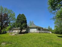 Charming home featuring a wrap-around deck perfect for outdoor relaxation and entertaining, surrounded by lush greenery at 4115 Tansel Rd, Indianapolis, IN 46234