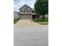 Charming two-story home with a two-car garage and inviting curb appeal on a sunny day at 5241 Waterton Lakes Dr, Indianapolis, IN 46237