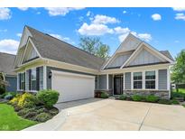 Beautiful home exterior highlighting a two-car garage and elegant stonework at 5850 Lyster Ln, Indianapolis, IN 46239