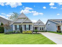 Charming home featuring a lush, well-maintained front yard and a classic exterior design at 5850 Lyster Ln, Indianapolis, IN 46239