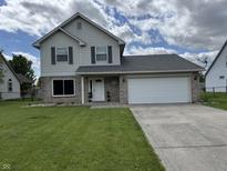 Charming two-story home featuring a brick facade, attached two-car garage, and well-maintained lawn at 660 White Ash Trail, Mooresville, IN 46158