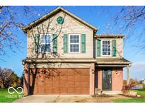 Charming two-story home features a front-facing two-car garage, green shutters, and a well-maintained lawn at 6756 Wimbledon Dr, Zionsville, IN 46077