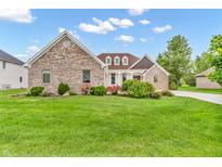 Inviting brick home with a manicured lawn and beautiful landscaping at 720 Willow Pointe North Dr, Plainfield, IN 46168