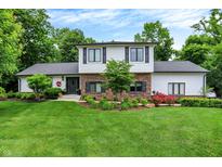 Charming two-story home with a brick and white exterior and a well-maintained landscaped front yard at 7255 Haverhill Ct, Indianapolis, IN 46250