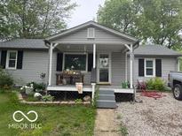 Charming single-story home with gray siding and welcoming front porch at 7504 N Green Meadows, Fairland, IN 46126