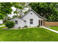 Charming home with gray siding, lush green lawn, and a welcoming walkway leading to a screened-in porch at 7536 Mccord St, McCordsville, IN 46055