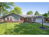 Charming brick home with a well-manicured lawn and inviting curb appeal at 9104 W Lone Beech Dr, Muncie, IN 47304