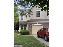 Inviting two-story home with a brick facade, manicured lawn, and an attached single-car garage at 9535 Longwell Dr, Indianapolis, IN 46240