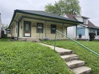 Charming single-story home featuring a welcoming front porch and a well-maintained lawn at 1546 Wade St, Indianapolis, IN 46203