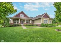 Charming home with a manicured lawn, professional landscaping, and a welcoming front porch at 16071 Prince Ct, Noblesville, IN 46062