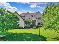 Stately two-story home with a well-manicured lawn, mature trees, and a classic brick facade at 16316 Brookhollow Dr, Westfield, IN 46074