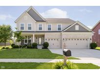 Charming two-story home featuring a well-manicured lawn, a three-car garage, and classic architectural details at 18763 Abigail Cir, Westfield, IN 46062