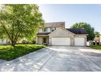 Charming two-story home featuring a three car garage, well-manicured lawn, and mature trees at 197 Ceejay Dr, Greenwood, IN 46142