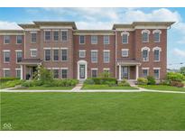 Beautiful brick townhome with well-manicured lawn and charming landscaping at 2436 Gwinnett St, Carmel, IN 46032