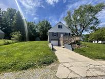 Charming home featuring a well-maintained lawn, a driveway, and a welcoming front porch at 2911 E 35Th St, Indianapolis, IN 46218