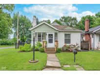 Charming cottage-style home with a landscaped front yard, a garden, and a welcoming entrance at 4641 Ralston Ave, Indianapolis, IN 46205