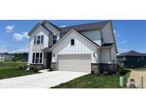 Beautiful two-story home with a neutral color scheme, a two-car garage, and a well-manicured front yard at 6338 Rippling Rock Dr, Plainfield, IN 46168