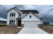 New two-story home featuring a two-car garage, brick accents, and a modern design under a cloudy sky at 6338 Rippling Rock Dr, Plainfield, IN 46168