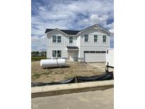 Charming new two-story white home with black roof, garage, and unfinished front yard at 7172 Finley Creek Dr, Whitestown, IN 46075