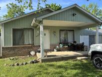 Charming single story home featuring a covered porch and well maintained lawn at 8936 E 46Th St, Indianapolis, IN 46226