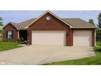 Brick home features an attached two-car garage with a well-maintained lawn at 994 Young'S Creek Dr, Franklin, IN 46131