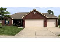 Charming brick home with a well-maintained lawn and a spacious two-car garage at 994 Young'S Creek Dr, Franklin, IN 46131