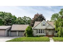 Charming single-story home with a well-maintained lawn, two car garage and inviting front porch at 1101 E Loretta Dr, Indianapolis, IN 46227