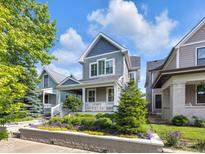 Charming two-story home with manicured front yard landscaping and inviting front porch at 1322 Marlowe Ave, Indianapolis, IN 46202