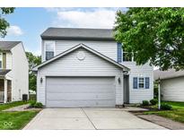 Charming two-story home features a gray garage door and light-blue shutters at 15411 Wandering Way, Noblesville, IN 46060