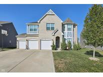 Charming two-story home with three-car garage and well-maintained front lawn at 1664 Woodside Cir, Franklin, IN 46131