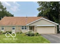 Charming home featuring a stone facade, attached two-car garage, and beautiful lawn at 18906 Crestview Ct, Westfield, IN 46074