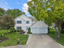 Charming two-story home with a well-maintained lawn, large tree, and a two car garage at 24 Cinnamon Ct, Brownsburg, IN 46112