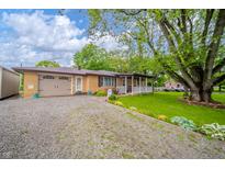 Charming ranch-style home with a well-maintained lawn, gravel driveway, and welcoming front porch at 2900 Helms Rd, Anderson, IN 46016