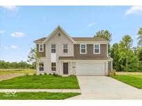 Beautiful two-story home with a brick and vinyl facade, well-manicured lawn, and a two car garage at 331 Oxford Ln, Lebanon, IN 46052