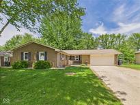 Charming single story brick home features an attached two car garage and a well maintained lawn at 3400 Debra Dr, Anderson, IN 46012