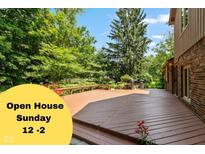 Large back deck offers outdoor living with grilling space, seating, and lush green surroundings at 3479 Sugar Loaf Ct, Carmel, IN 46033