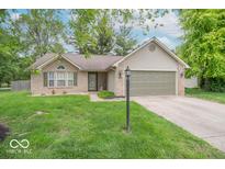 Charming one-story home with a brick facade, attached garage, and a well-manicured lawn at 3898 Chelsea Ter, Greenwood, IN 46143