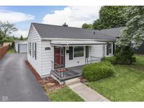 Charming home featuring a well-maintained yard and a welcoming red door at 454 E Broadway St, Greenwood, IN 46143