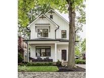 Charming two-story modern farmhouse featuring black window trim and inviting front porch at 5254 N Park Ave, Indianapolis, IN 46220