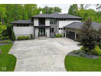 Stunning contemporary home with stone accents, a large driveway, and lush landscaping at 7070 Dean Rd, Indianapolis, IN 46220