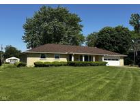 Charming single-story home with a well-manicured lawn, a garage, and lovely curb appeal at 7127 Lincoln St, Anderson, IN 46013