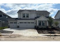 New construction two-story home featuring a spacious three-car garage and modern architectural details at 7145 Firestone Rd, Whitestown, IN 46075