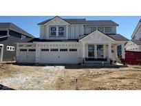 Charming new two-story home featuring a three-car garage and modern architectural details at 7145 Firestone Rd, Whitestown, IN 46075